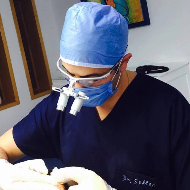 Dr Fares Seffen during a procedure, wearing surgical loupes